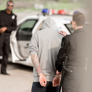 A man being escorted by police officers