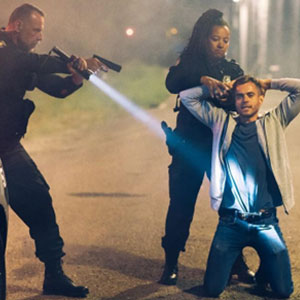 Law enforcement officers subduing a man during an arrest